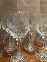 Front view showing entire set of pinwheel cut wine glasses