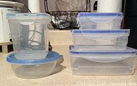 Left: tall square container on round bowl; right: stack of three rectangular containers