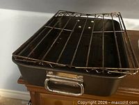 Angled view of roasting pan and rack showing front handle