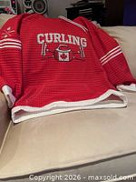 Front view showing curling graphic and overall design