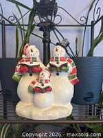 Front view of one snowman family figurine set showing colors and design