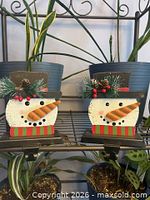 Pair of snowman stocking holders on shelf