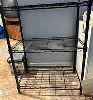 front view of black three-tier wire shelving unit