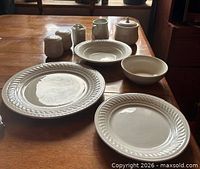 Group view of representative dinner plate, side plate, soup bowl, cereal bowl, salt and pepper, creamer, lidded sugar bowl