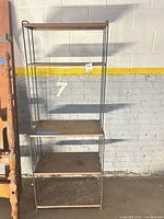 front view of five-shelf metal unit against wall