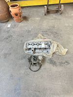 Cylinder head and carburetor on floor
