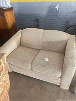 Front view of beige 2-seater loveseat