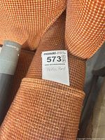 Close-up of sofa fabric texture and lot tag