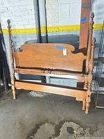 Full view of assembled bed frame showing headboard, footboard and rails