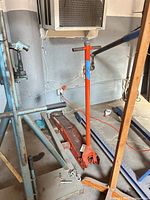 Full view of hydraulic floor jack with handle attached