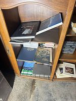 Books on shelf showing variety of large-format volumes