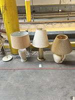 Group shot of three table lamps with shades showing overall condition and styles