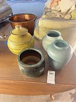 All four pottery pieces on table
