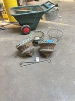 Four hanging planter baskets, liners and hooks on warehouse floor