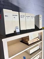 Five white magazine file holders labeled misc., Car & Driver, AutoWeek