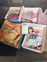 Four boxed Madame Alexander dolls with boxes and tissue