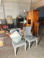 Pair of gray velvet wingback chairs in warehouse setting