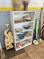 Front view of white painted bookcase with four shelves
