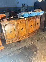 Front view of buffet base showing four paneled doors with knobs