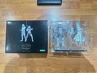 Closed box beside opened clamshell showing two stormtroopers and accessories