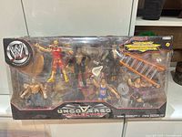 Sealed WWE Uncovered Collection box with six figures and accessories