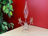 Full view of clear glass bud vase with two gold-accented hummingbirds and floral base