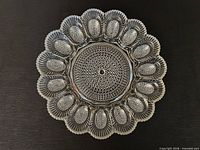 Front view of clear Indiana Glass hobnail deviled egg plate showing scalloped rim and central well
