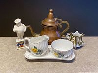 Group shot of all six items: Adderley creamer, sugar bowl, tray, copper teapot, decorative vase, porcelain figurine