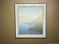 Framed minimalist mountain lake print hanging on wall
