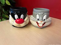 Front view of both character mugs, Bugs Bunny and Sylvester