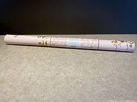 Full view of unopened Tempaper wallpaper roll showing label and pattern