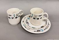 two mugs and two plates showing overall design