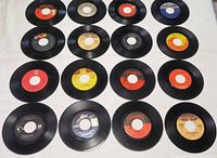 Sixteen 7" singles arranged in 4×4 grid showing all labels