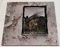 Front jacket showing artwork of man carrying sticks