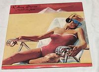 Front album cover showing artwork of woman on lounge chair