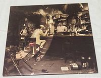 Front of outer jacket showing bar scene artwork variant