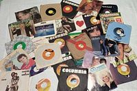 Spread of all 30 records showing variety of labels and picture sleeves