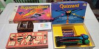 Overview of all five boxed games on table