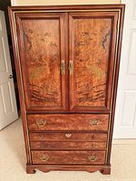 Full front view showing doors with crane inlay and lower drawers