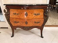 Front view of serpentine burl wood commode with ormolu mounts and marble top