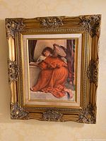 Front view showing entire framed angel print with ornate gilded wooden frame