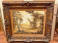 Front view of oil landscape painting in ornate gilt frame