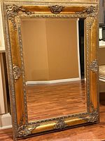 Full view of rectangular mirror showing entire gilded wood frame and reflective surface