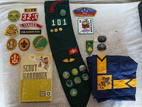 Full lot view showing sash, handbook, neckerchief, patches and pins