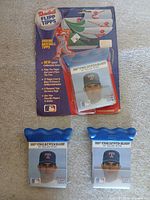 Overall view of all three Nolan Ryan Flipp Tipps packs, showing one sealed blister pack and two loose packs