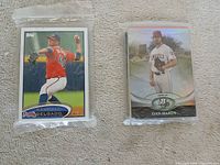 Front view of sealed pack showing Randall Delgado Topps card and second sealed pack showing Dan Haren Bowman card
