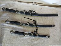 Three decorative swords laid out together showing size differences and full view