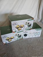 Three retail boxes of egg slicers stacked