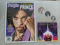 Group shot of magazine, CD and three pinbacks