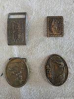 Overview of all four buckles on cloth background